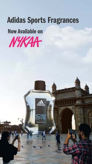 Man Climbs at Perfume Bottle in a fake-out-of-home ad of Nykaa