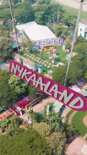 Pink Parachutes Carrying Signage in a fake-out-of-home ad of Nykaa