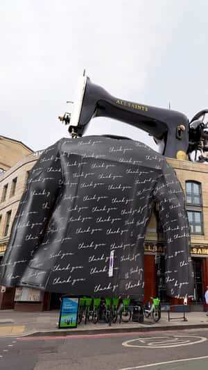 Sewing Machine Stitches Leather Jacket in a fake-out-of-home ad of AllSaints