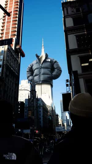 Empire State Building Wearing Black Jacket in a fake-out-of-home ad of JD Sports