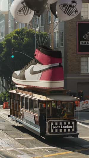 Sneaker on Balloons Lands on Cable Car in a fake-out-of-home ad of Foot Locker