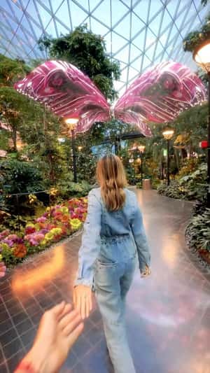 Giant pink butterfly at the airport orchard fake-out-of-home ad of Qatar Airways