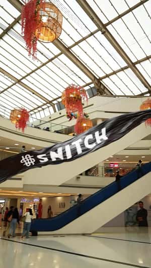 Black Banner Flying Above Buildings in a fake-out-of-home ad of Snitch