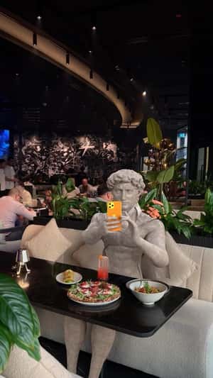 Marble Statue Taking Photo in a fake-out-of-home ad of Amaya