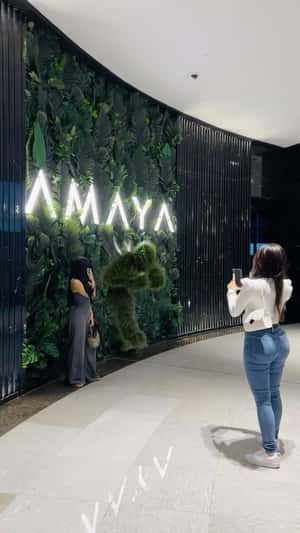 Grass Man Emerges From Wall Display in a fake-out-of-home ad of Amaya