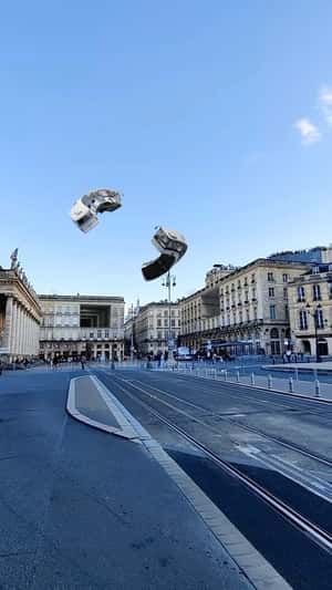 Buses Flying Above the City in a fake-out-of-home ad of Quoifaireabordeaux