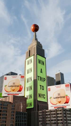 Package on Parachute and Raining Apples in a fake-out-of-home ad of Waterdrop
