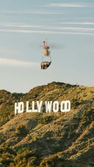 Helicopter with Banner Soars Above Hollywood in a fake-out-of-home ad of LA GOLF