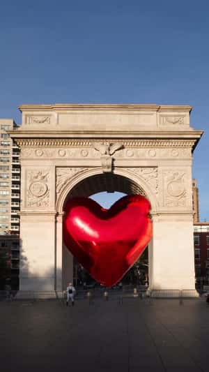 Heart Balloon Squeezing on Arch in a fake-out-of-home ad of DKNY