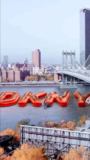 Inflatable Letters Float at the River in a fake-out-of-home ad of DKNY