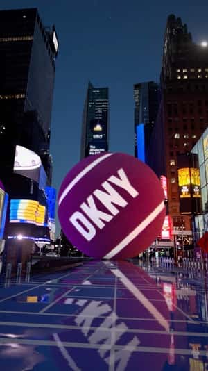 Tennis Balls Rolling at Times Square in a fake-out-of-home ad of DKNY