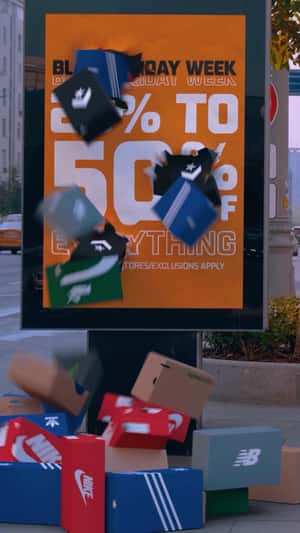 Shoe Boxes Burst Out From Street Ad in a fake-out-of-home ad of Foot Locker