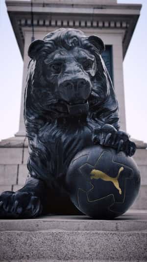 Lion Statue Holds Soccer Ball in a fake-out-of-home ad of PUMA