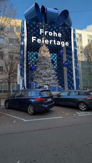 Building Gift Box Reveals Christmas Tree in a fake-out-of-home ad of Volksbank