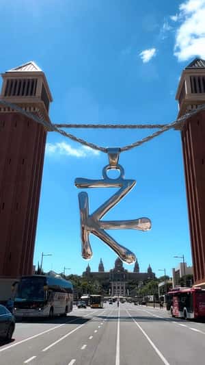 Necklace Hangs from Towers in a fake-out-of-home ad of Nombdi