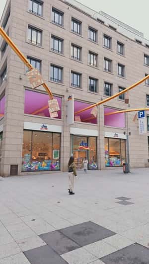 Shopping Bags Gliding on the Conveyor in a fake-out-of-home ad of DM