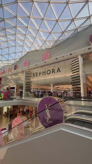 Blush Powder Riding on Escalator in a fake-out-of-home ad of Sephora