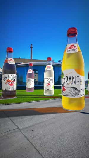 Soda Bottles Standing Near Brewery in a fake-out-of-home ad of Stieglitz Limonade