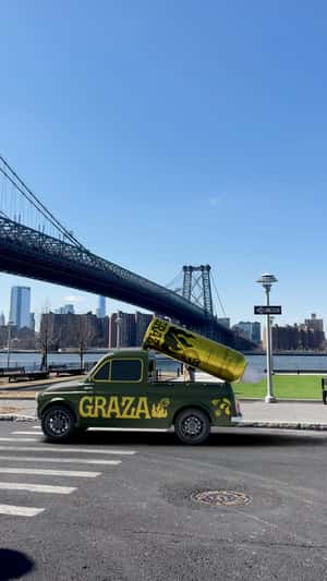 Pick Up Truck with Spraying Oil Bottle in a fake-out-of-home ad of Graza