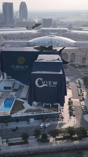 Living Whales Floating on Covered Building in a fake-out-of-home ad of Qatar Living Properties