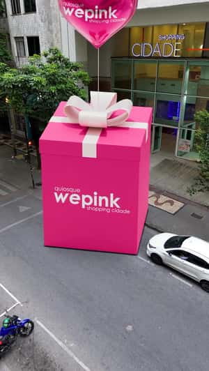 Heart Balloon Carries Pink Gift Box in a fake-out-of-home ad WEPINK