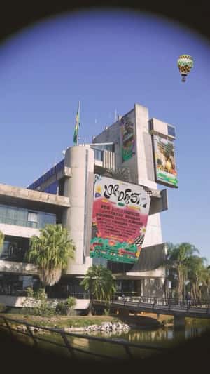 Poster and Screen Ads Hang on Building in a fake-out-of-home ad of Lobofest