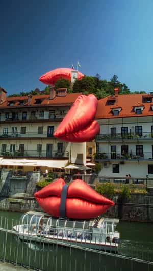 Tied Inflatable Lips Above Boat in a fake-out-of-home ad of Smile