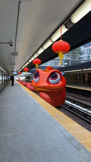 Red Snake Slithers on Train Station in a fake-out-of-home ad of Toronto Transit Commission