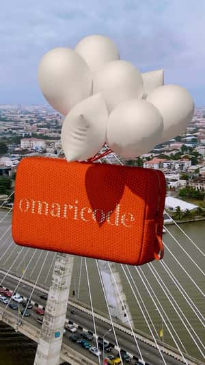 Purse Carried by Balloons in a fake-out-of-home ad of Omaricode