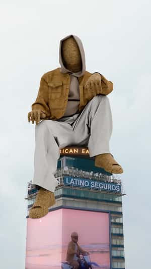 Sand Man Sits on Top of Building in a fake-out-of-home ad of American Eagle