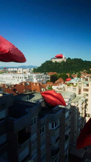 Inflatable Red Lips Resting Above Castle in a fake-out-of-home ad of Smile