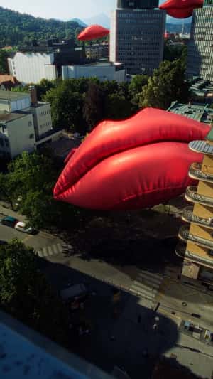 Inflatable Red Lips Installed on Buildings in a fake-out-of-home ad of Smile