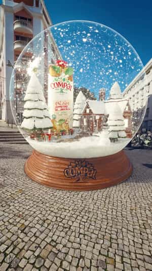 Juice Pack Stands Inside Snow Globe in a fake-out-of-home ad of Compal