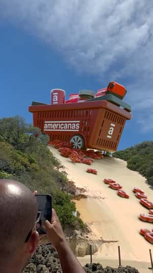 Grocery Basket Stuck on Sand Dunes in a fake-out-of-home ad of Americanas