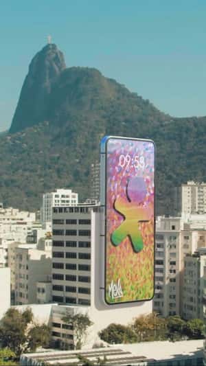 Flip Phone Opens as it Hangs on Building in a fake-out-of-home ad of Vivo
