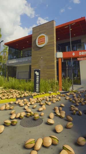 Pistachio Nuts Raining at Restaurant in a fake-out-of-home ad of Burger King