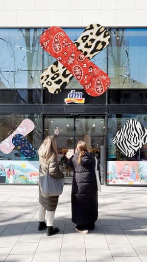 Plasters Covering Cracked Glass Wall at DM Market in fake-out-of-home ad of DM