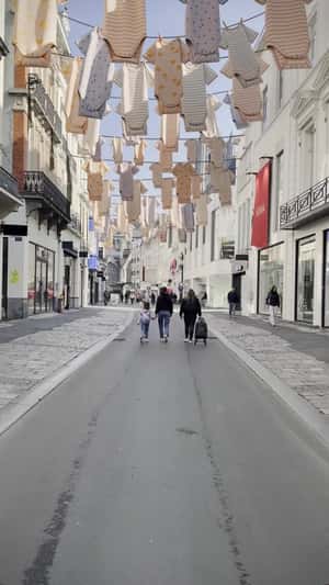 Baby Clothes Hanging Above Shopping Street in a fake-out-of-home ad of HEMA