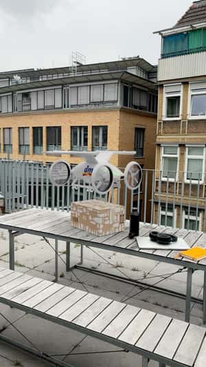 Drone delivering package in fake-out-of-home ad of DM