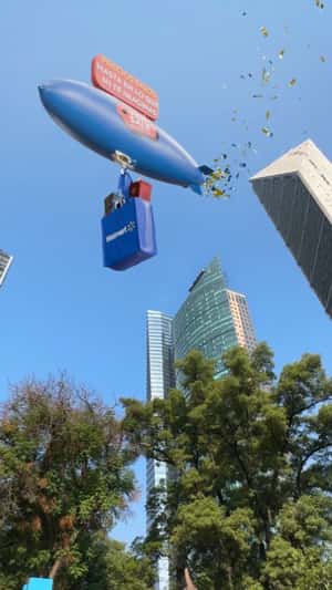 Airship Floats Above Skyscraper in a fake-out-of-home ad of Walmart