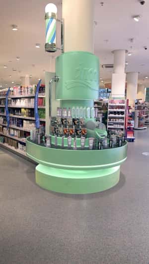 Beauty products on conveyor belt in fake-out-of-home ad of DM