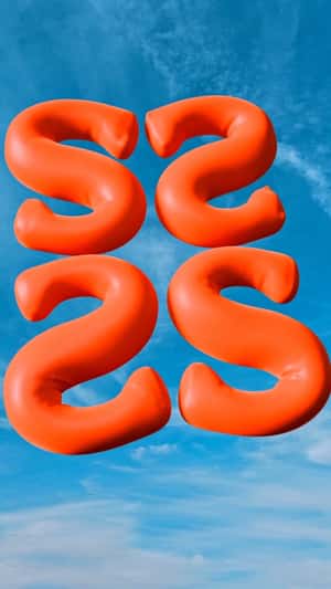 Orange Letter Balloons Float in a fake-out-of-home ad of Shopbop