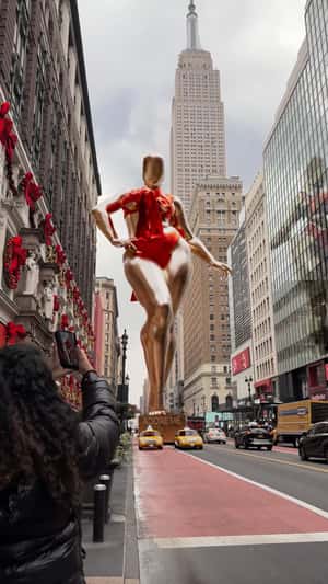 Golden Mannequin Pulled by Taxi Cabs in a fake-out-of-home ad of Adore Me