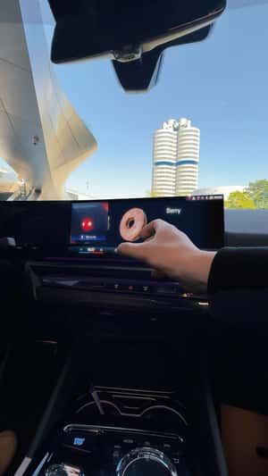 Donut Emerges From Dashboard Screen in a fake-out-of-home ad of BMW