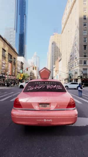 Pink Gloss Cab Roaming in NYC in a fake-out-of-home ad of Fenty Beauty