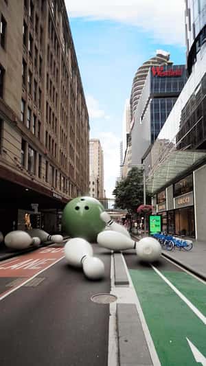 Bowling Ball Strikes Pins on the Street in a fake-out-of-home ad of The Commons