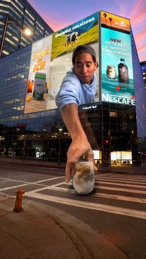 Man Puts Coffee on Street from Screen in a fake-out-of-home ad of Nestlé