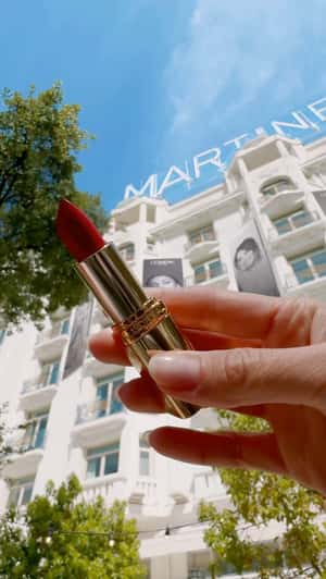 Lipstick Grabbed from Hanging Banner in a fake-out-of-home ad of L'Oréal