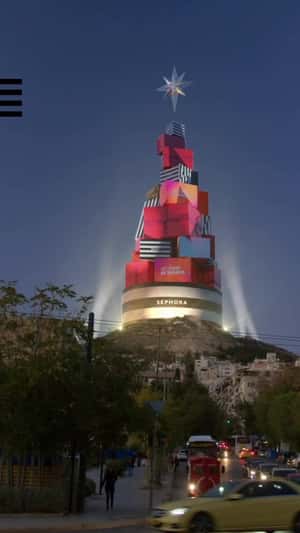 Gift Boxes Christmas Tree on a Hill in a fake-out-of-home ad of Sephora