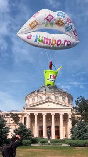 Lip Balloon Carries Bucket with Shovels in a fake-out-of-home ad of Jumbo